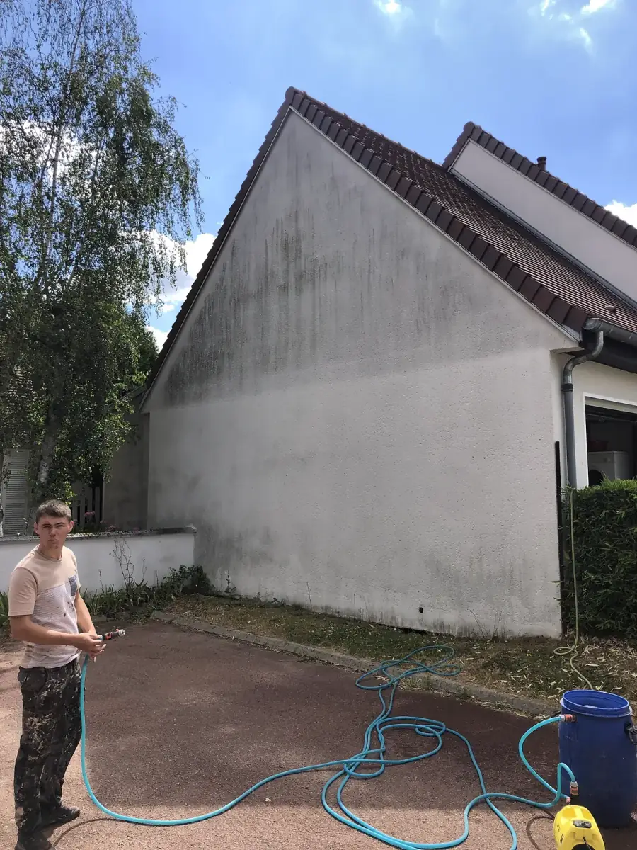 M. Renaud lavant au jet basse pression le pignon d'une maison en Eure-et-Loir (28)